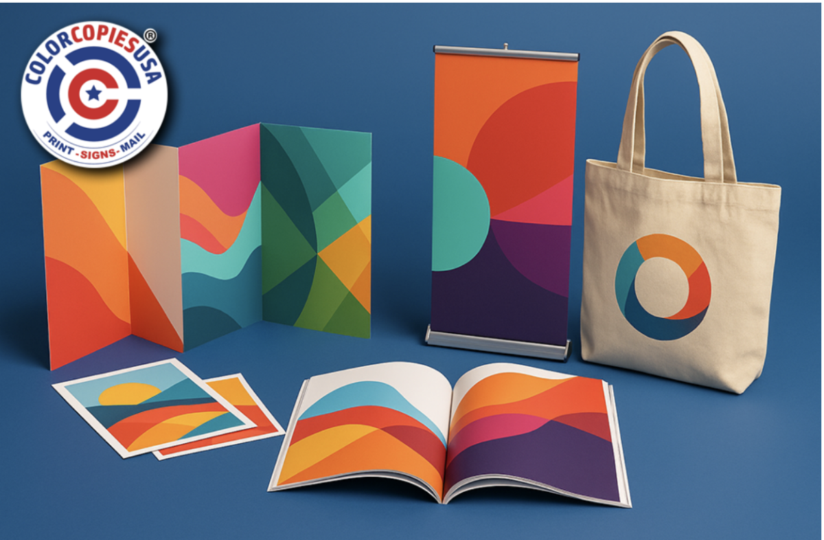 A collection of items printed by Color Copies USA, including a tote bag, a retractable banner, flyers, a brochure, and a booklet